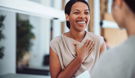 Smiling woman with hand on her heart